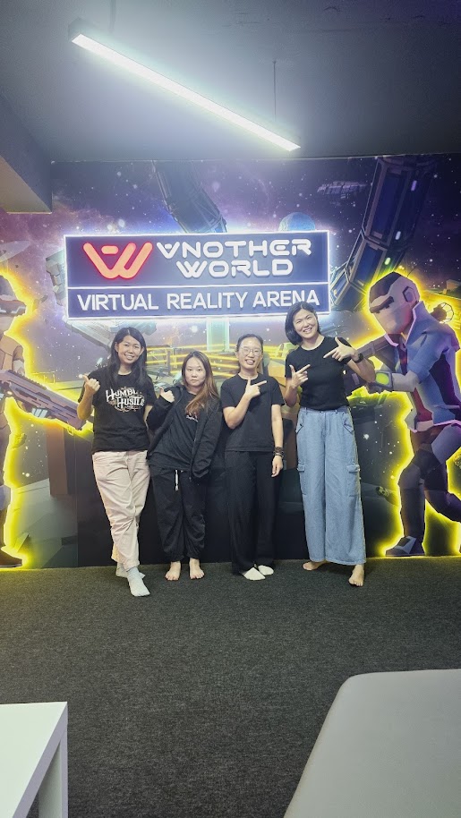 Colleagues celebrating at a branded event wall